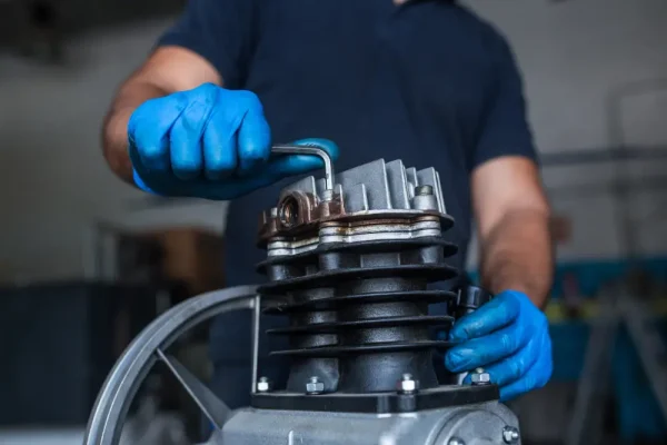 mechanic-fixing-a-compressor-engine-2023-11-27-04-52-58-utc
